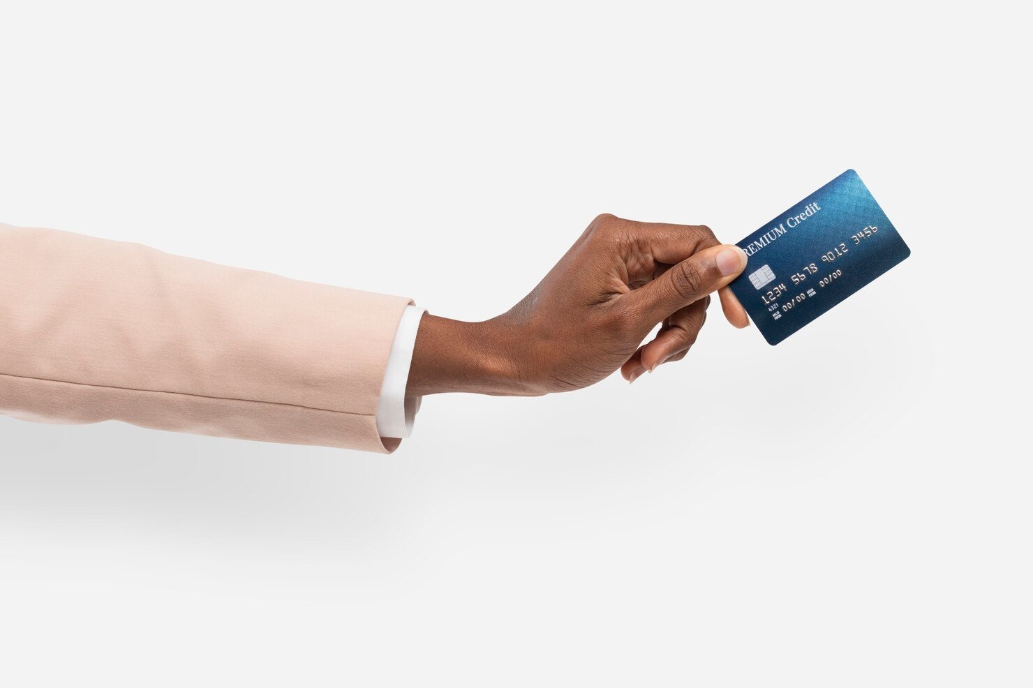 A hand holding out a credit card A hand in a beige suit jacket holds a blue credit card against a white background, conveying themes of finance, professionalism, and transaction.
